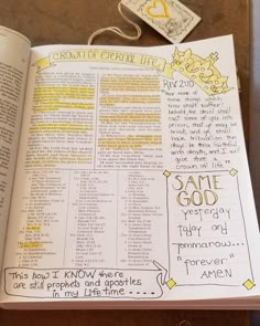 an open bible with some writing on the page and tags attached to it that read,