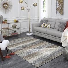 a living room filled with lots of furniture next to a white wall and flooring