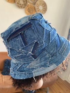 the back of a man's head wearing a denim hat with holes on it