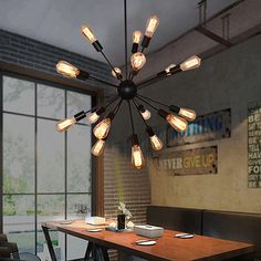 a dining room table and chairs with lights hanging from the ceiling above it in front of large windows