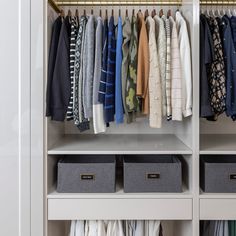 an organized closet with clothes and boxes