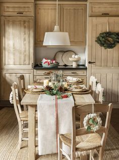 a dining room table set for christmas dinner