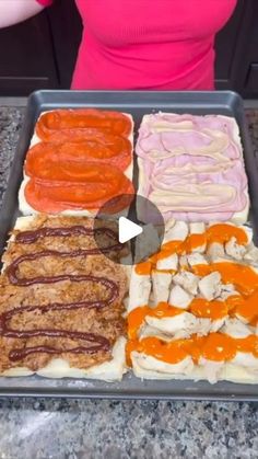 a woman standing in front of a tray filled with different types of food