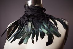 This Collar Necklace is handmade from cotton lace wings and feathers. It has beautiful dyed black half bronze rooster schlappen feathers. The feathers sewn with a trim so they don't fall off. Zoom in to see the details! It has straps for closure and are made from durable cotton or leather with grommets.  One size fits most S-M-L   This Collar necklace is one of a kind handmade collar bib feather wings necklace. Thank you for looking. I have similar ones. Check out my shop! FREE SHIPPING in the STATES by First Class Mail with a Tracking info. See All One-of-a-Kind Items - Vegan and Genuine Leather Belts - Clothing - Accessories: www.etsy.com/shop/Suniq Feather Outfit, Feather Accessories, Lace Wings, Feather Collar, Raven Feather, Wings Necklace, Bib Collar, Cloth Belt, Feather Wings