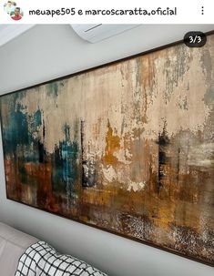 a large painting hanging on the wall in a living room