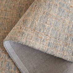 closeup of the fabric on an upholstered chair with a blue and brown checkered pattern