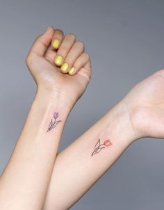 two small tattoos on both arms, one with an arrow and the other with a flower