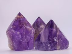 three ametholite pyramids sitting on top of each other