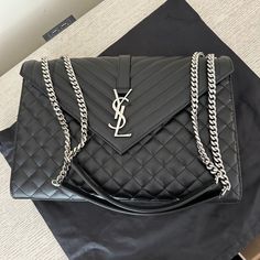 Never Worn Brand New Envelope Triquilt Large Ysl Shoulder Bag In Grained Leather Saint Laurent Shoulder Bag In Chevron/Diamond-Quilted, Chrome/Metal-Free Tanned Leather. Silver Metal Hardware. Sliding Chain And Leather Shoulder Straps, Doubled 11.8 Drop And Unfolded 20.4 Drop. Envelope Flap Top With Ysl Logo; Magnetic Closure. Exterior, One Slip Pocket At Back. Interior, Grosgrain Lining; One Slot Pocket. 8.6H X 12.2W X 2.9D. Approx. Weight 2.3 Lb. Ysl Shoulder Bag, Yves Saint Laurent Paris, Fringe Bags, Chrome Metal, Saint Laurent Paris