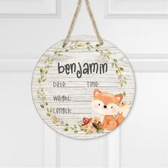 a wooden sign hanging from the side of a door with a fox and leaves on it