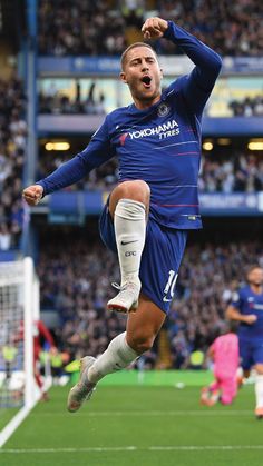 the soccer player is jumping in the air with his arms wide open as he celebrates