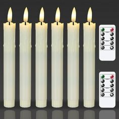 six white candles with remote controls next to each other