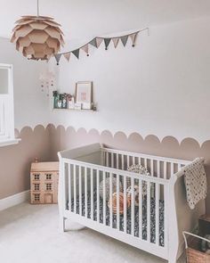 a baby's room with a white crib and wooden toys on the floor