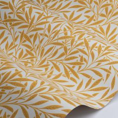 a wallpaper with gold leaves on white and yellow background, as well as an image of