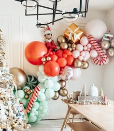 a christmas tree with balloons hanging from it