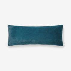 a blue velvet pillow on a white background