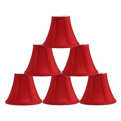 six red lampshades are stacked up in a pyramid formation on a white background