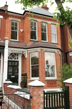 a large brick house with white trim and windows