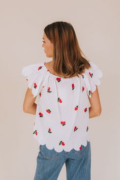 Get ready to fall in love with our Cherry Lover Top! This off-white shirt features delicate embroidered cherries, scalloped edges, and flutter sleeves for a playful touch. Made with sheer material and an elastic boat neckline, this top is both feminine and fun. (Cherry-picked perfection!) Details Off-white shirt with embroidered cherries Scalloped edges Flutter sleeves Sheer material Elastic boat neckline Sizing Approximate measurements: SIZE LENGTH BUST Small 23" 40" Medium 23.5" 42" Large 24" White Short Sleeve Tops With Scalloped Edges, White Scalloped Edges Short Sleeve Top, White Tops With Scalloped Edges And Short Sleeves, Sweet White Tops With Strawberry Print, Short Sleeve Cotton Tops With Scalloped Edges, Cotton Short Sleeve Tops With Scalloped Edges, Cotton Tops With Scalloped Edges And Short Sleeves, White Sweet Tops For Summer, Sweet Cotton Summer Top