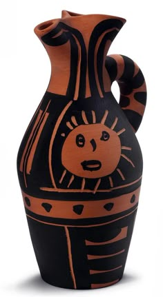 a black and orange vase with an image of a cat on it's side