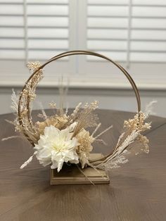 a white flower arrangement in a circular basket