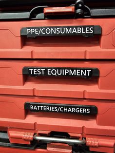 three red tool boxes with labels on them that say test equipment, batteries, and pec / consumables