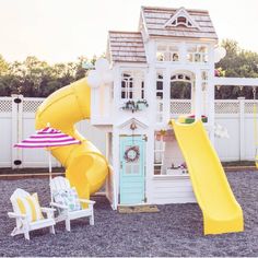 a house with a slide and chairs in the yard