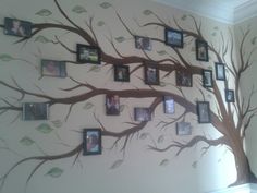 a family tree with many pictures hanging on it's branches and leaves painted on the wall