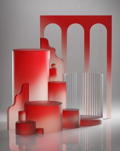 red and white vases sitting next to each other on top of a reflective surface