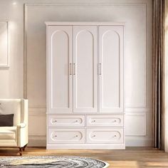 a white armoire in a room with a rug on the floor and a chair next to it