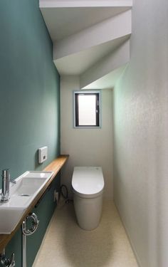 a bathroom with a toilet, sink and window