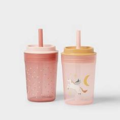 two sippy cups with unicorns on them, one is pink and the other is yellow