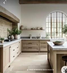 a large kitchen with lots of counter space and wooden cabinetry, along with an arched window