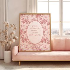 a pink couch sitting in front of a window next to a vase filled with flowers