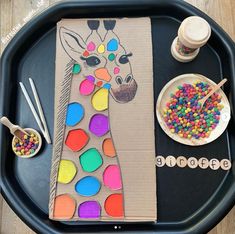 a tray with some crafting supplies on it and a giraffe paper bag