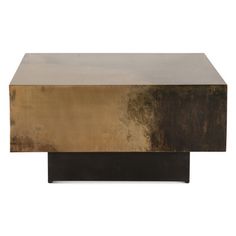 a gold and black coffee table sitting on top of a white floor