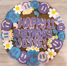 a decorated birthday cake with the words happy birthday jose spelled in blue and pink icing