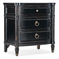 an antique black dresser with three drawers and two pulls on the bottom drawer, one door open