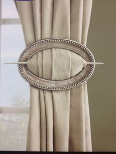 an image of a window with curtains and draperies in the background that has a fish - shaped design on it