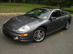 a gray sports car parked in a parking lot