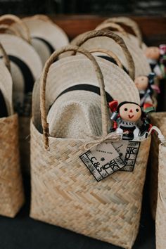 baskets with hats and dolls in them are on the table next to each other,