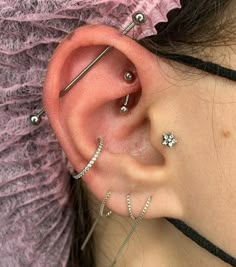 a woman with three piercings on her ear