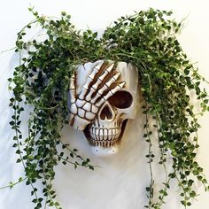 a fake skull with green vines around it