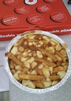 a pie sitting on top of a counter next to a red box