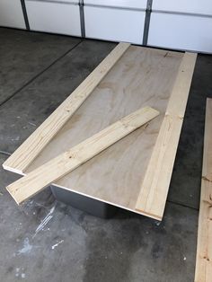 two pieces of plywood are laying on the floor