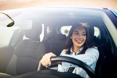 a woman sitting in the driver's seat of a car