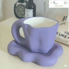 a purple coffee cup sitting on top of a counter