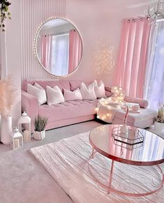 a living room filled with pink furniture and decor on top of carpeted flooring