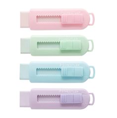 four pastel colored plastic utensils are lined up in a row on a white background