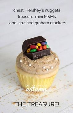 there is a cupcake with candy on it and the caption reads, the treasure